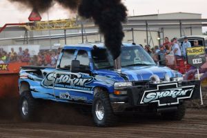pulling truck blowing black smoke at truck pulling event