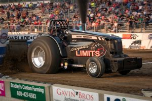 Beyond Limits tractor at a tractor pulling event outside in front of a crowd of people Beyond Limits tractor at a tractor pulling event outside in front of a crowd of people