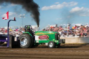 Green tractor tractor pulling with black smoke coming out the top Green tractor tractor pulling with black smoke coming out the top