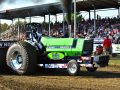 bright green tractor pulling outside