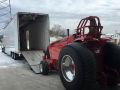 red tractor entering semi