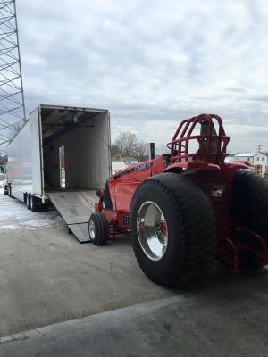 red tractor entering semi red tractor entering semi