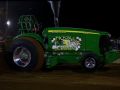 green pulling tractor outside in the evening