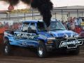 pulling truck blowing black smoke at truck pulling event