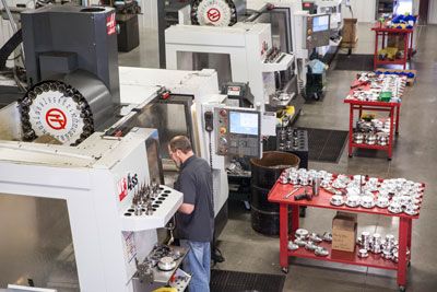 Employee using CNC Machine for performance parts